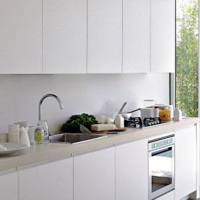 Modern White Kitchen With Great Natural Lighting and Slidding Glass Door