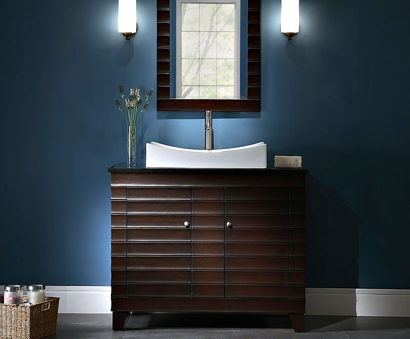 bathroom sink with wooden cabinet